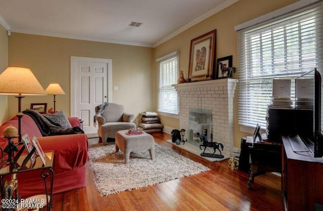 1015 Lee Ave, Lafayette, LA 70501 - living room featuring wood finished floors, a brick fireplace, and crown molding