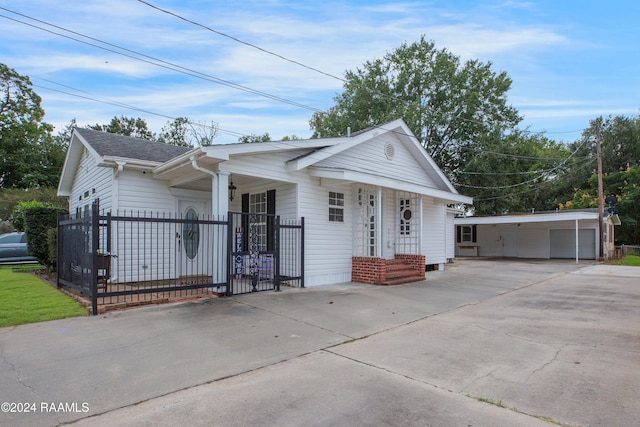 view of front facade featuring a garage, a porch, and an outbuilding