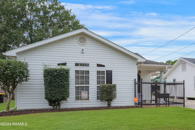 rear view of house with a lawn