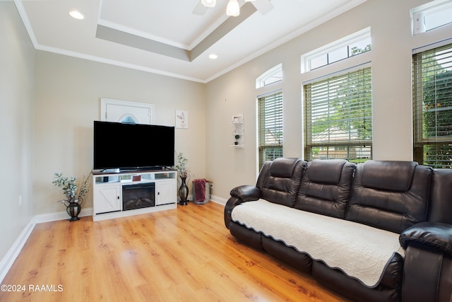 living room featuring ornamental molding, light hardwood / wood-style floors, and ceiling fan