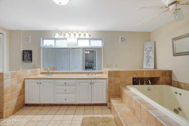 bathroom featuring tile patterned floors, tile walls, vanity, ceiling fan, and a relaxing tiled tub