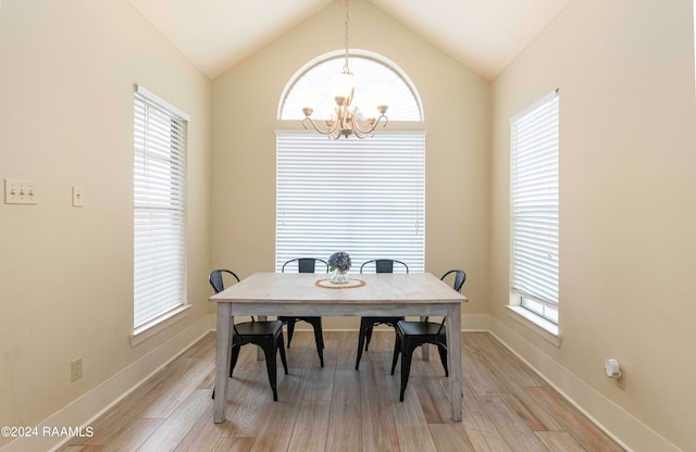 dining room with light wood-type flooring, lofted ceiling, and a healthy amount of sunlight