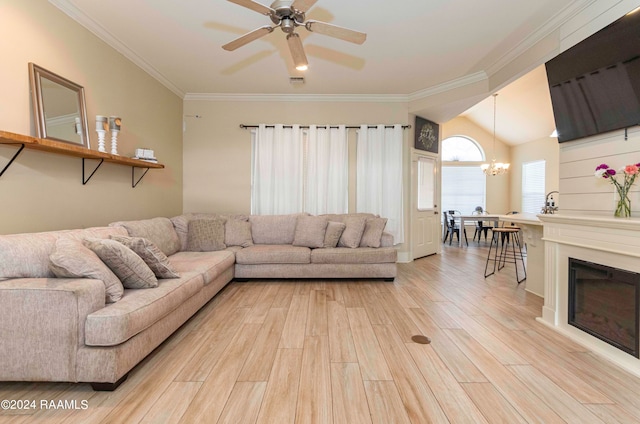 living room featuring lofted ceiling, ceiling fan with notable chandelier, crown molding, and light hardwood / wood-style flooring