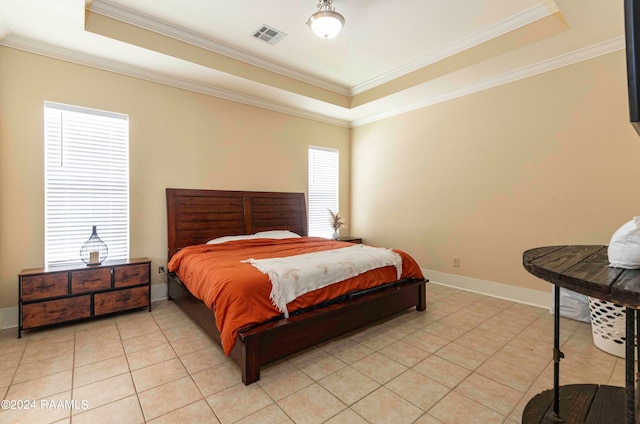 tiled bedroom with ornamental molding, multiple windows, and a tray ceiling