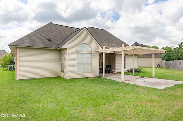 rear view of property featuring cooling unit, a pergola, a yard, and a patio area