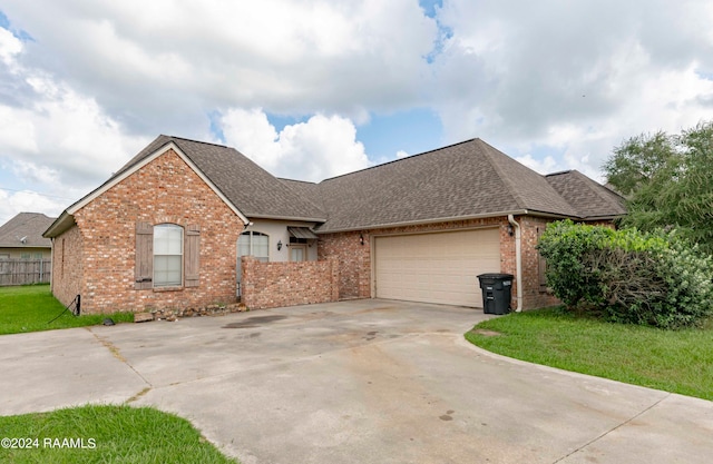 view of front of home with a garage and a front lawn