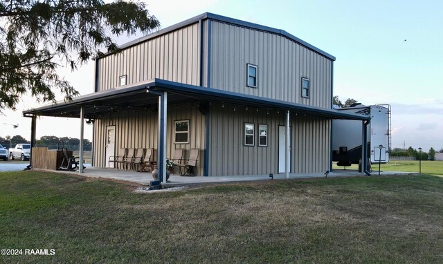 2213 Mills St, Lafayette, LA 70507 - rear view of house with board and batten siding and a lawn