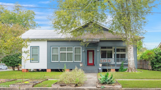 bungalow-style home featuring a front yard