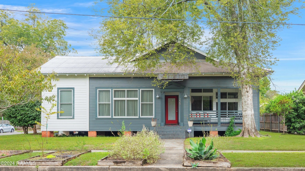228 Cherry St, Lafayette, LA 70506 - view of front of home featuring a vegetable garden and a porch