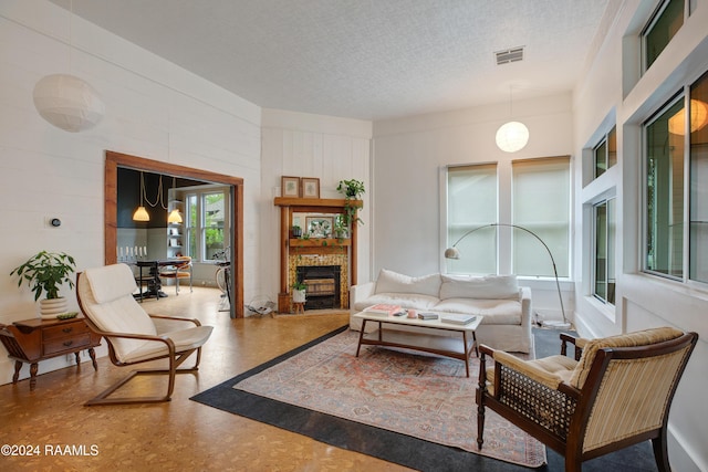 228 Cherry St, Lafayette, LA 70506 - living room with a fireplace with raised hearth and a textured ceiling