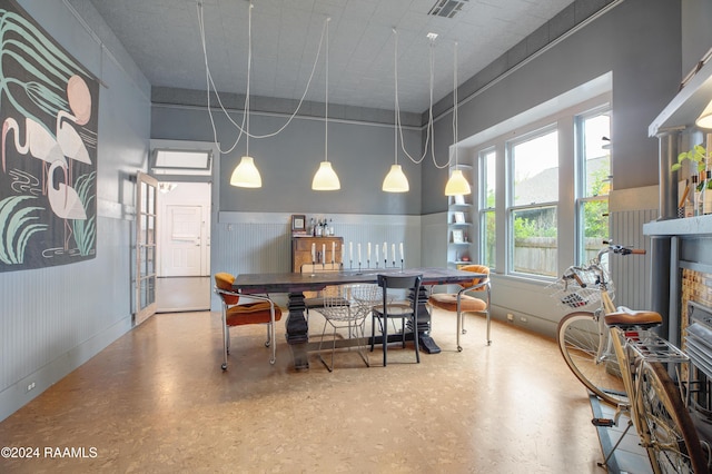 228 Cherry St, Lafayette, LA 70506 - dining space featuring a wainscoted wall and a fireplace