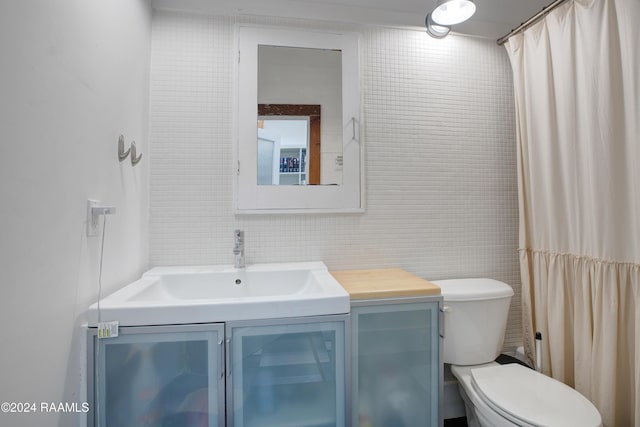 228 Cherry St, Lafayette, LA 70506 - bathroom with tile walls, vanity, and toilet