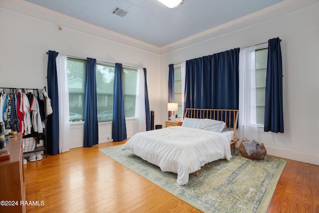 228 Cherry St, Lafayette, LA 70506 - bedroom featuring ornamental molding, wood-type flooring, and baseboards