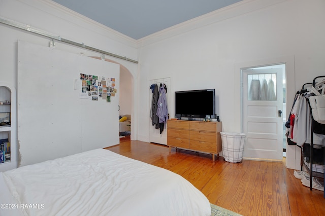 bedroom featuring crown molding and hardwood / wood-style floors