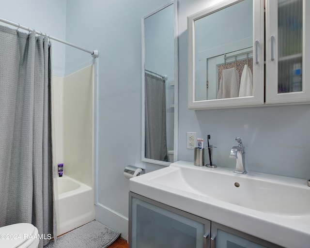 full bathroom with vanity, shower / bathtub combination with curtain, and toilet