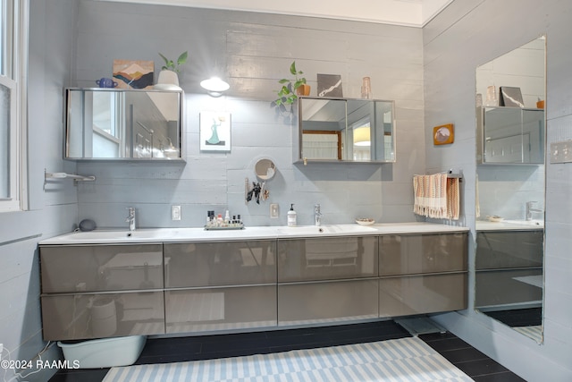 bathroom featuring vanity and tile walls