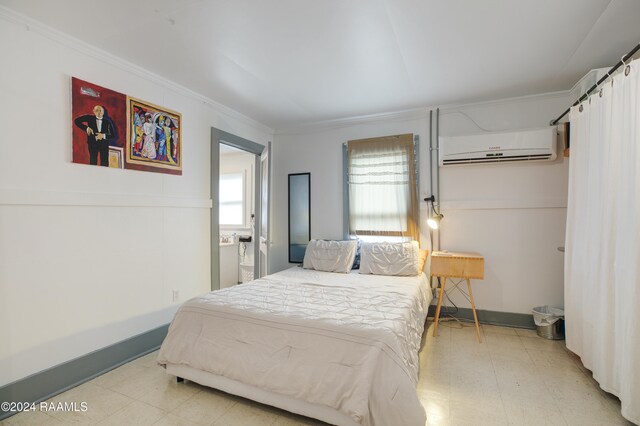 bedroom with ornamental molding and a wall unit AC