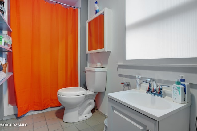 bathroom with tile patterned flooring, vanity, a shower with curtain, and toilet