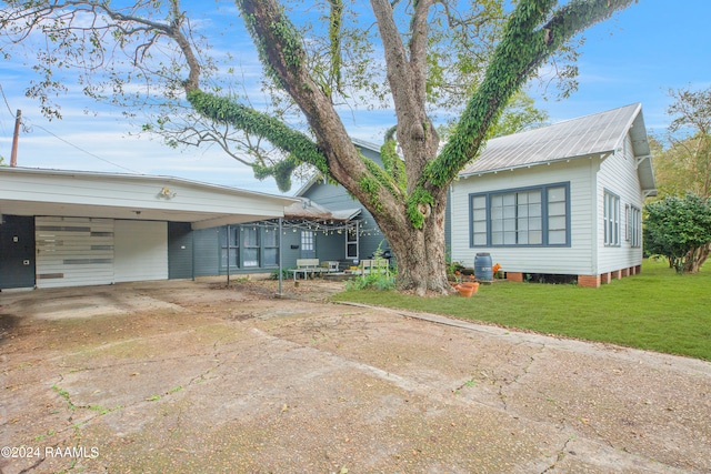 view of front of property featuring a carport and a front yard