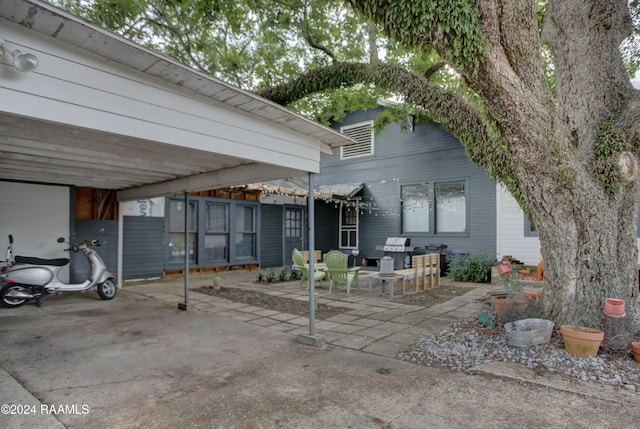 view of patio with area for grilling and a carport