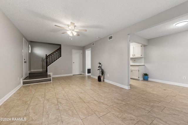 interior space featuring a textured ceiling and ceiling fan