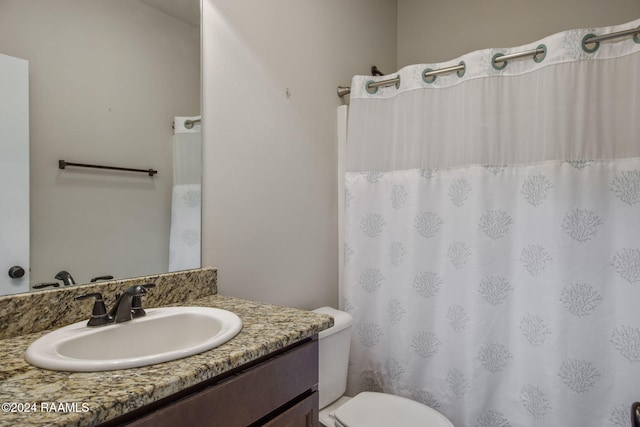 bathroom with toilet and vanity