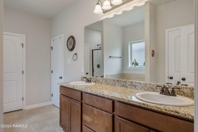 bathroom featuring vanity, tile patterned floors, and a shower with door