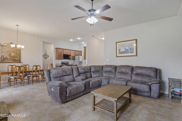 tiled living room with ceiling fan with notable chandelier