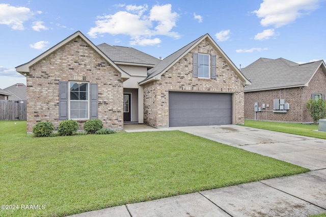 view of property featuring a garage and a front lawn