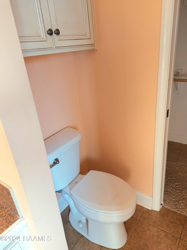 bathroom with tile patterned flooring and toilet