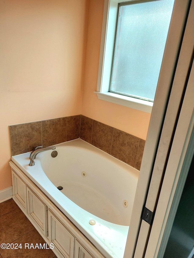 bathroom with a bath and tile patterned flooring