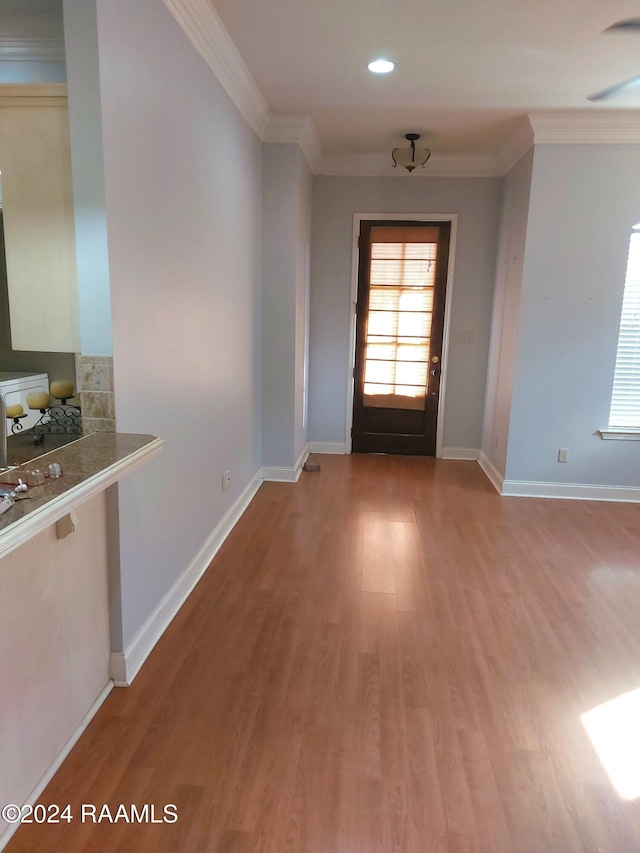 doorway featuring hardwood / wood-style flooring and ornamental molding