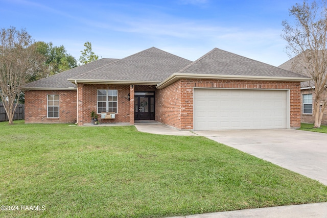 ranch-style home featuring a garage and a front lawn