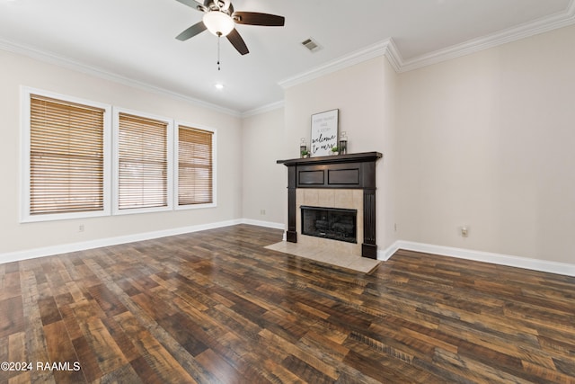 unfurnished living room with a fireplace, ceiling fan, ornamental molding, and dark wood-type flooring