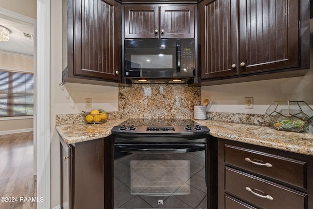 kitchen featuring black appliances, dark brown cabinets, wood-type flooring, and ornamental molding