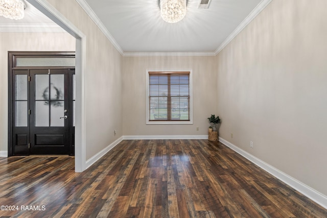 entryway featuring dark hardwood / wood-style flooring, crown molding, and an inviting chandelier