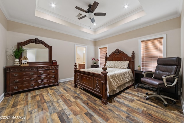 bedroom featuring ensuite bath, a tray ceiling, ceiling fan, crown molding, and dark hardwood / wood-style floors