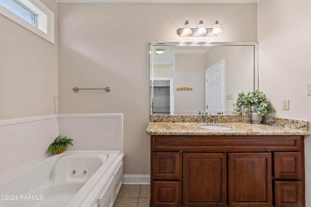 bathroom featuring tile patterned flooring, vanity, and a tub