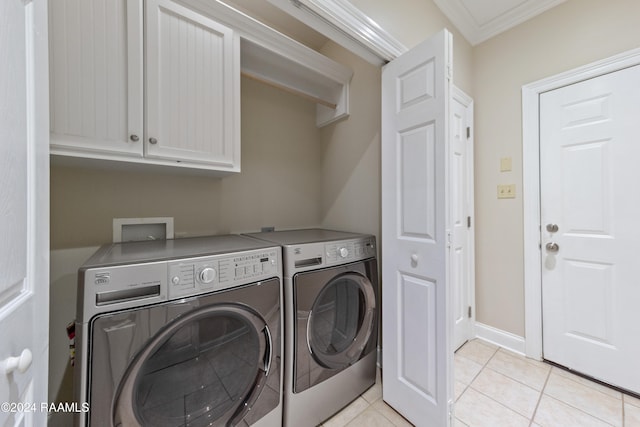 clothes washing area featuring crown molding, light tile patterned flooring, cabinets, and independent washer and dryer