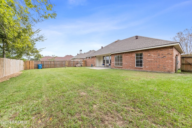 back of house featuring a yard and a patio