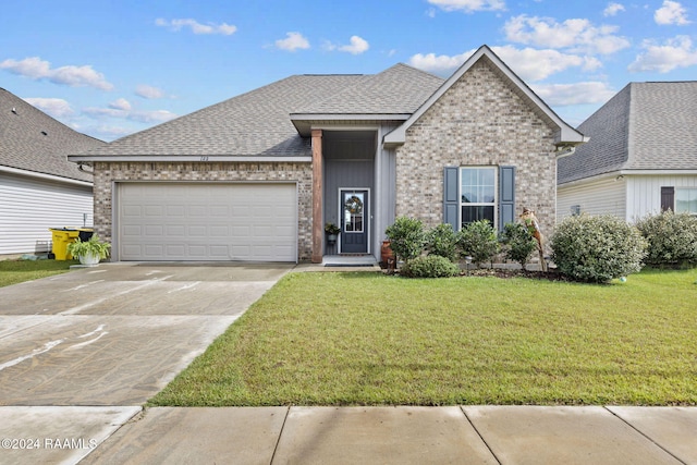 view of front of home with a garage and a front lawn