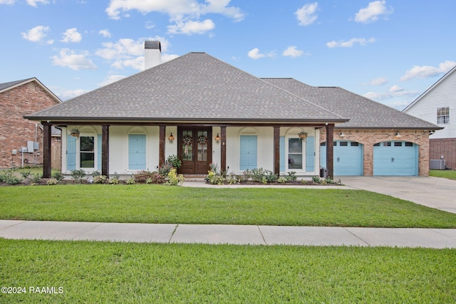 view of front of house with a front lawn, a garage, central AC unit, and a porch