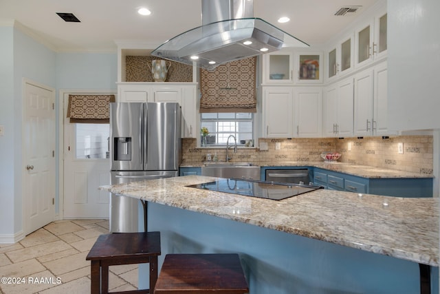 kitchen with light stone countertops, island exhaust hood, white cabinetry, and blue cabinetry