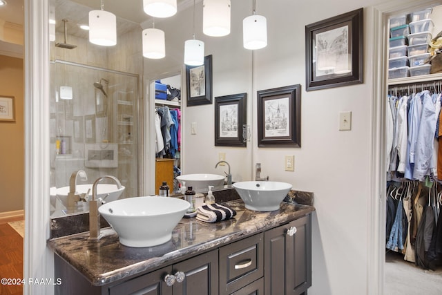 bathroom with an enclosed shower and vanity