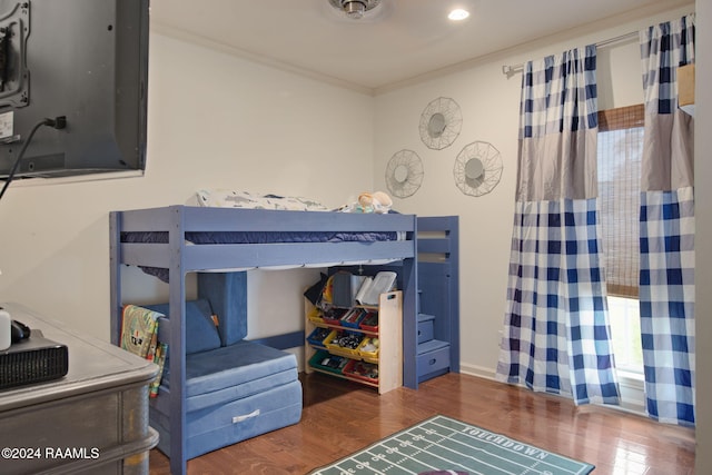 bedroom featuring dark hardwood / wood-style flooring and crown molding