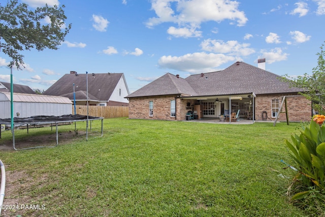 view of yard with ceiling fan, a patio, and a trampoline