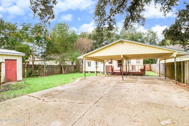 view of front facade with a front yard, a shed, and a deck