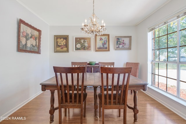 dining space featuring hardwood / wood-style flooring, plenty of natural light, and a notable chandelier