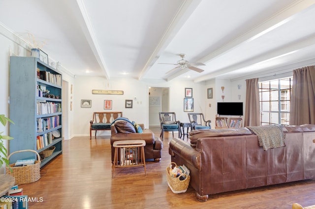 living room with hardwood / wood-style flooring, ceiling fan, and beam ceiling