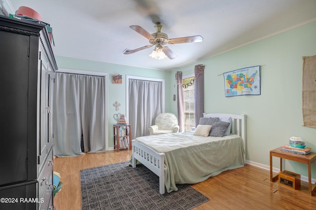 bedroom with ceiling fan and wood-type flooring